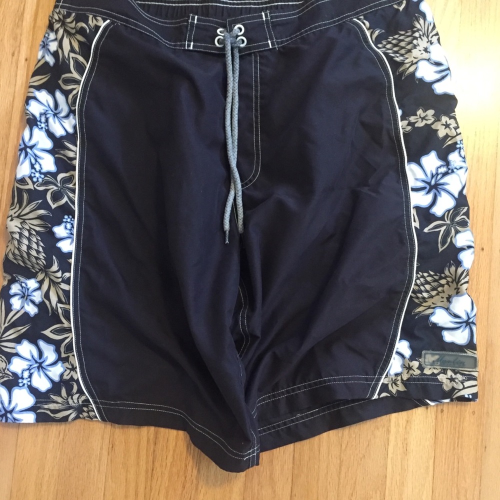 Black board shorts with aloha flower pattern